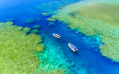 Aerial view of snorkelers near boats in the Whitsundays, Australia.