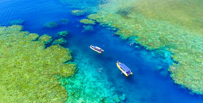 Whitsundays snorkel cruise boat near Hill Inlet, turquoise waters, Airlie Beach departure.