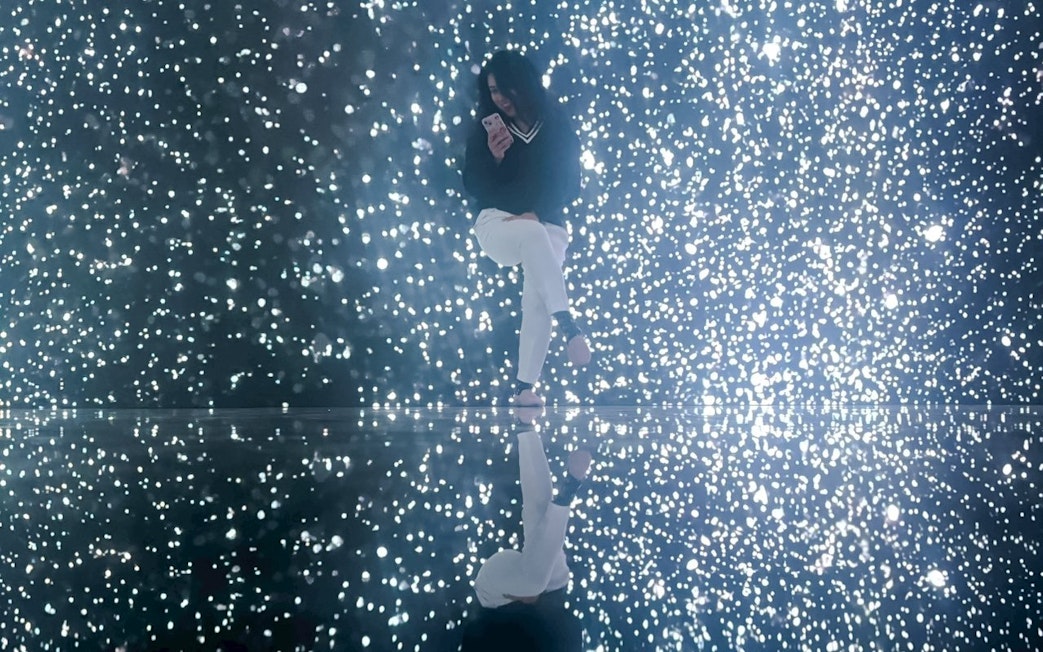 Tourist enjoying illuminated display at MIRACLEWORLD Osaka.