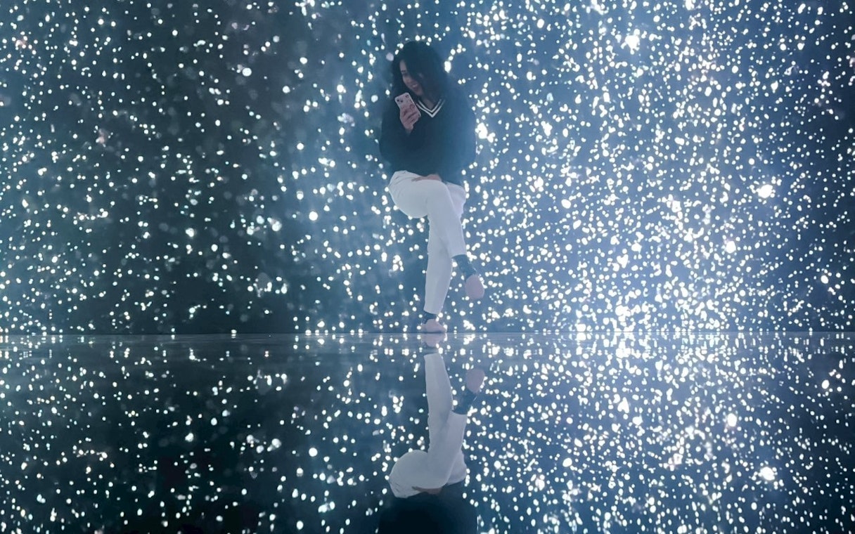 Tourist enjoying illuminated display at MIRACLEWORLD Osaka.