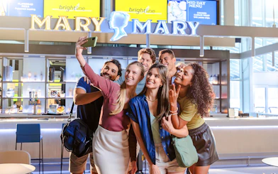 Group taking a selfie at Brightline station, Orlando to South Florida route.