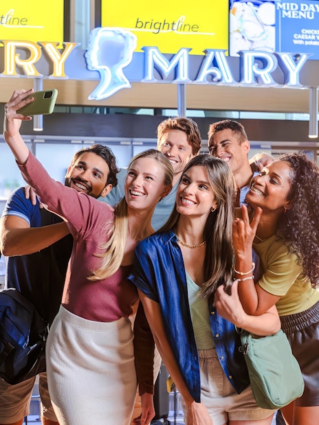 Group taking a selfie at Brightline station, Orlando to South Florida route.