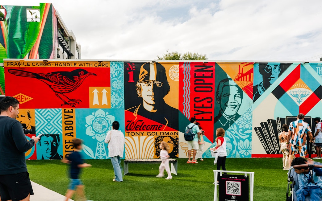 Wynwood Walls Museum visitors admire vibrant street art murals.