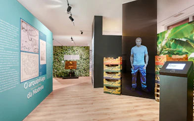 Madeira museum exhibit with historical maps and banana crates display.