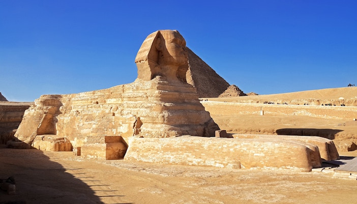 Sphinx in Cairo with the Great Pyramid in the background.