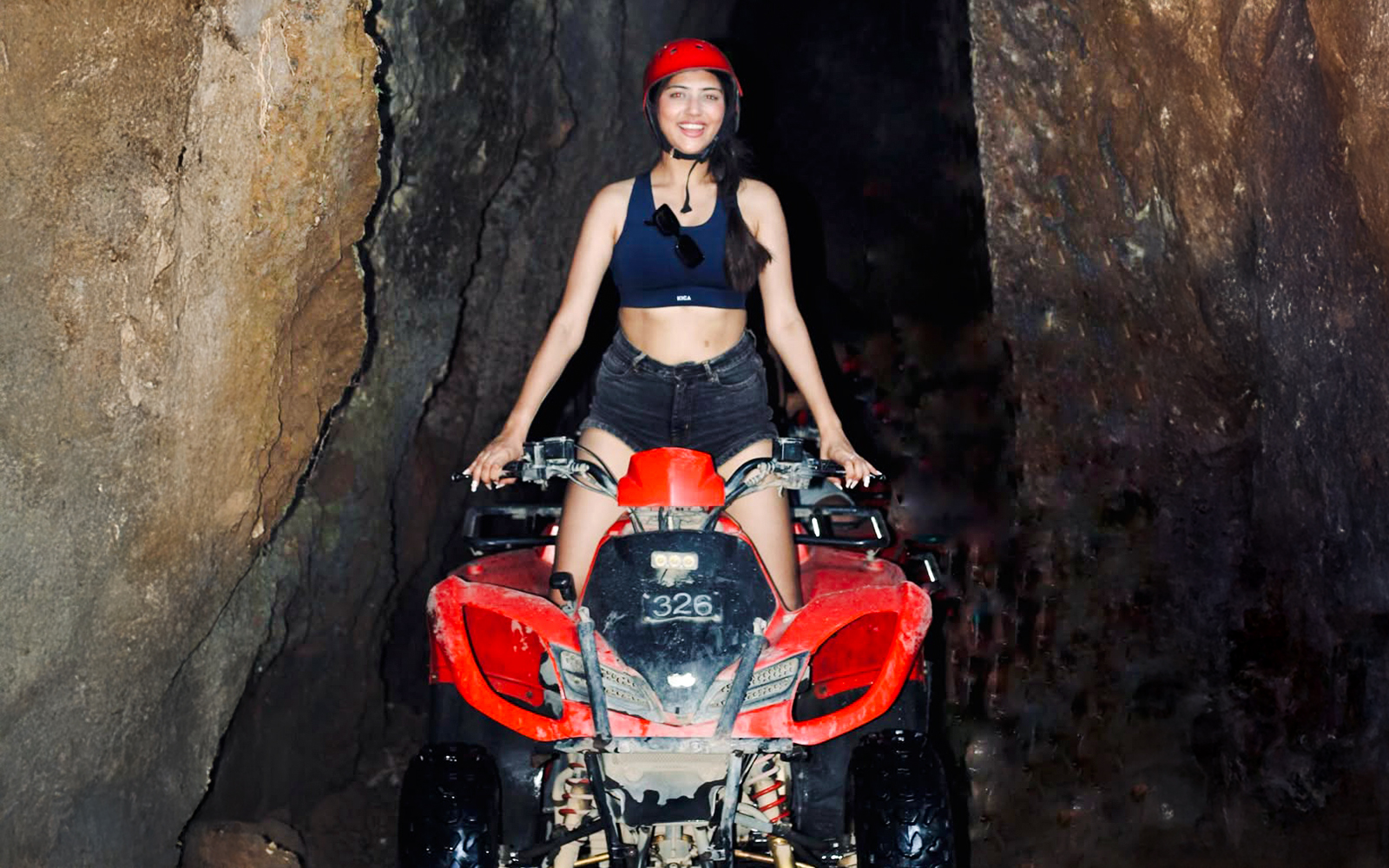 ATV ride through Kuber long tunnel with rider wearing helmet.