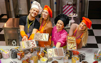 Participants in Vienna chocolate workshop displaying decorated chocolate bars.