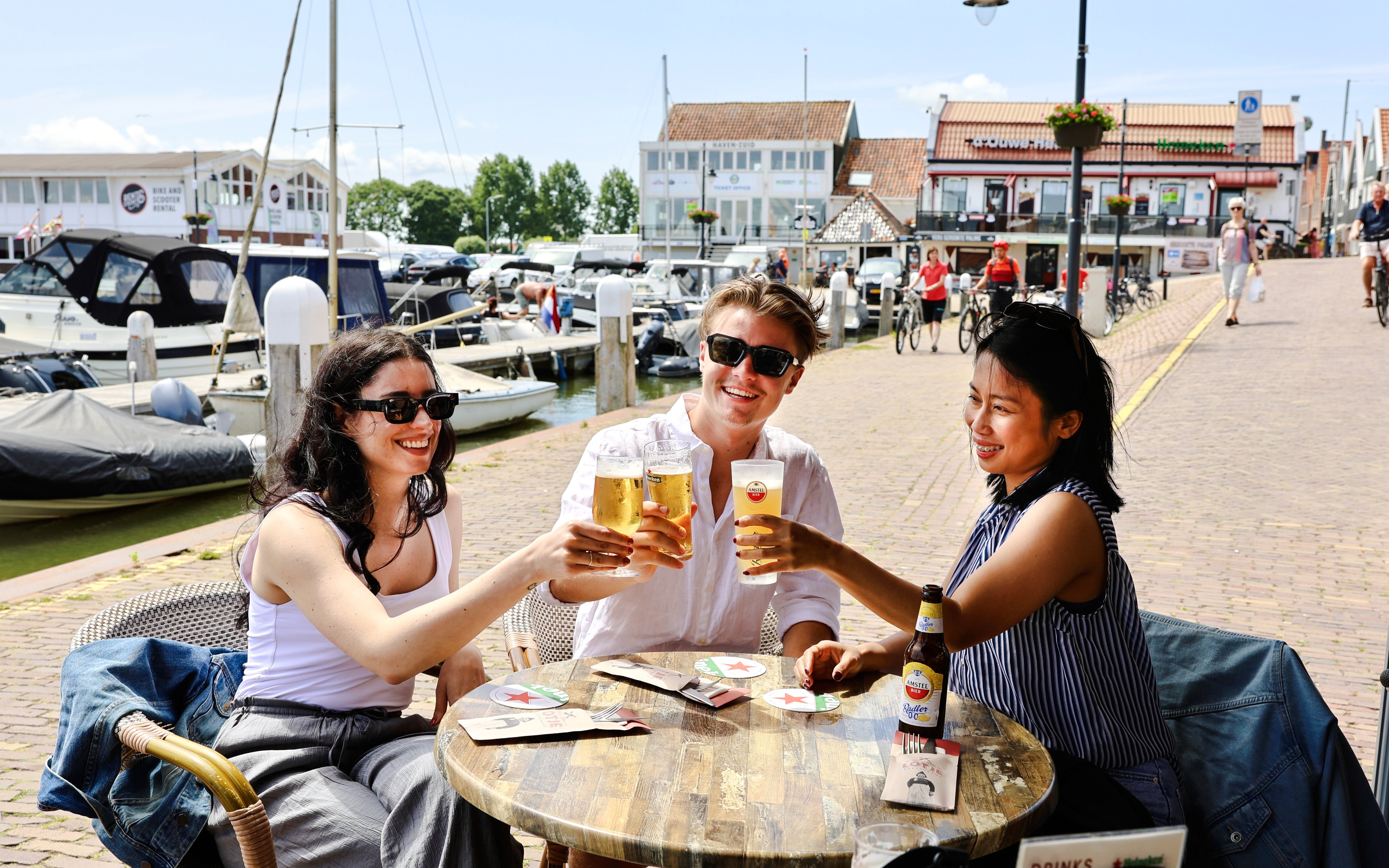 Guests enjoying drinks at a waterfront café in Volendam.