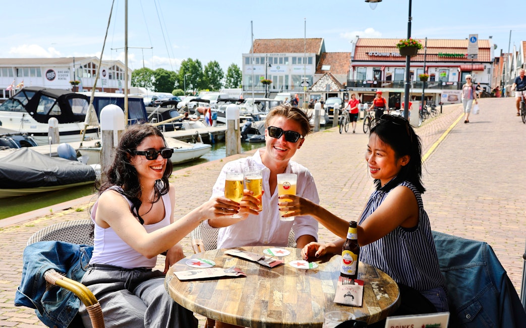 Guests enjoying drinks at a waterfront café in Volendam.