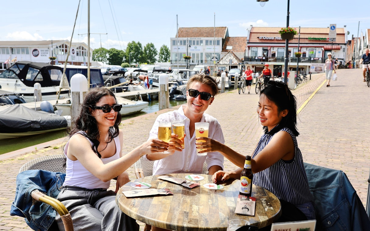 Guests enjoying drinks at a waterfront café in Volendam.