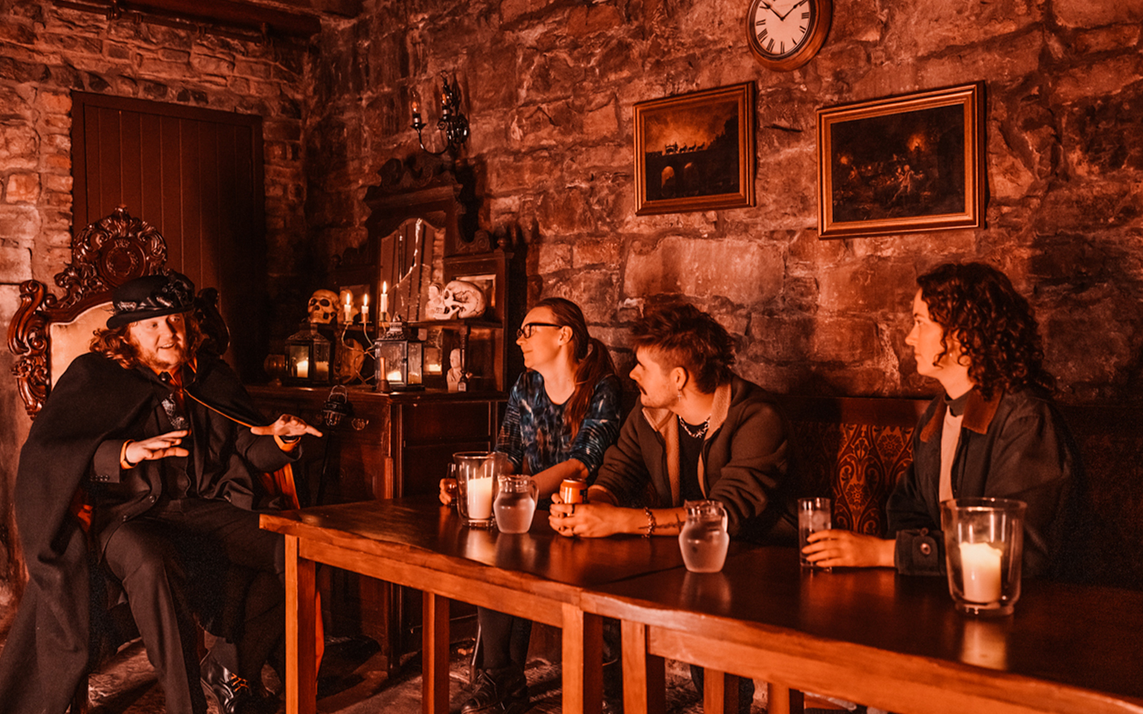 Edinburgh ghost tour guide narrating stories to visitors in a dimly lit underground room.