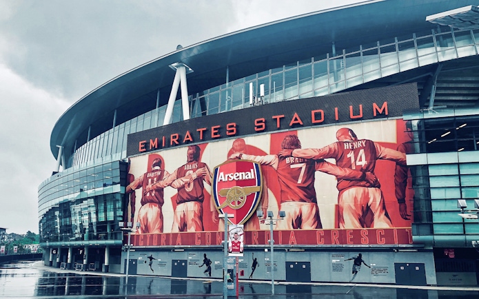 Emirates Stadium entrance with Arsenal FC mural, London.