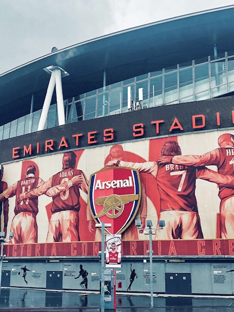 Emirates Stadium entrance with Arsenal FC mural, London.