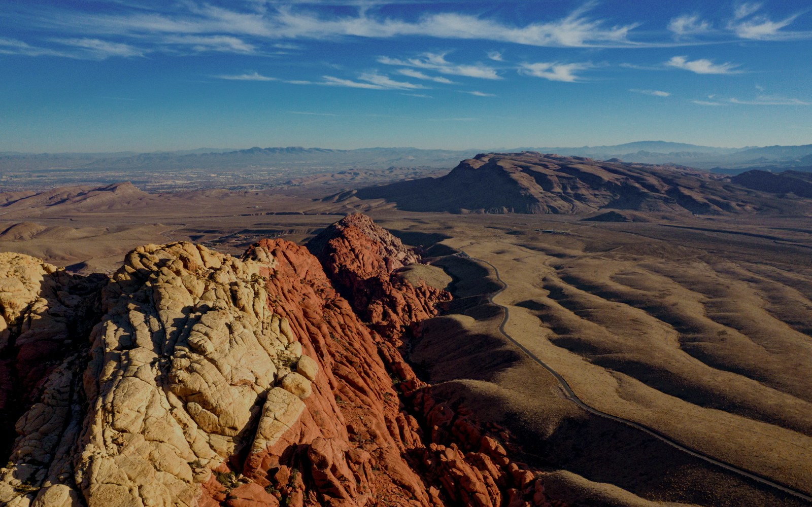 Helicopter flying over Red Rock Canyon landscape near Las Vegas.