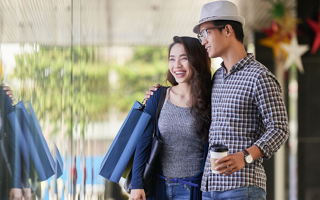Couple shopping near Maha Tower, Malaysia.