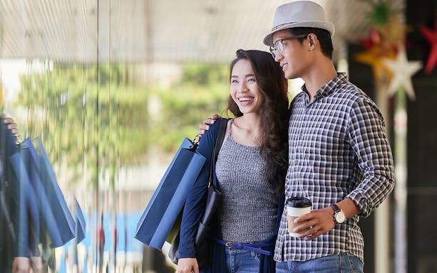 Couple shopping near Maha Tower, Malaysia.