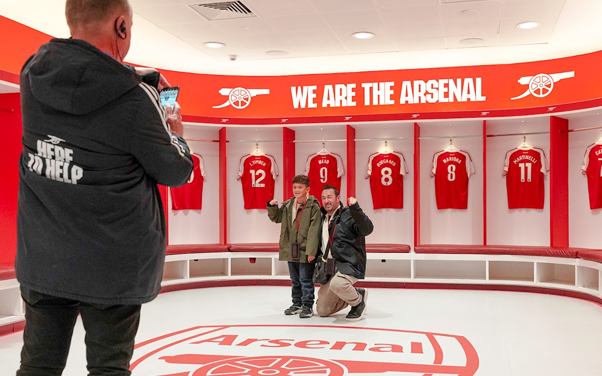 Visitors posing in the Arsenal dressing room at Emirates Stadium, London.