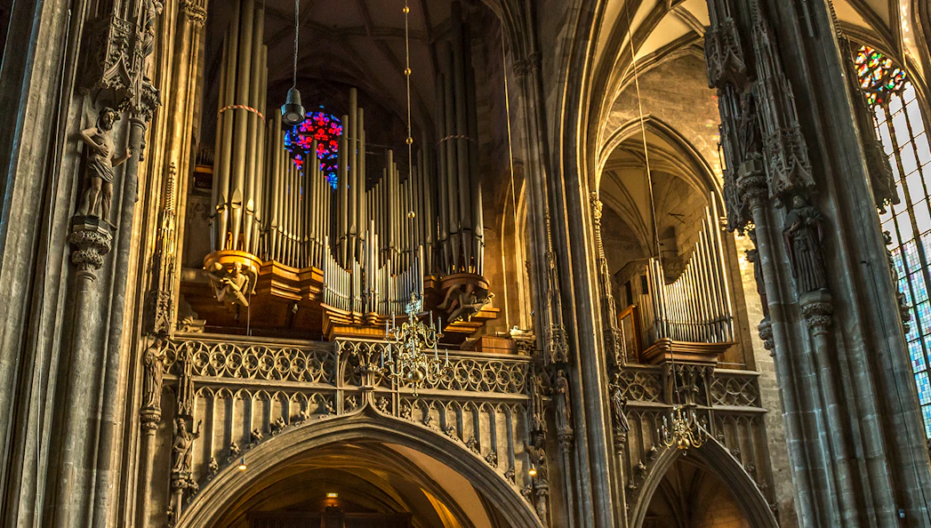 St. Stephen's Cathedral organ pipes and stained glass window in Vienna.