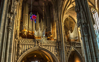 St. Stephen's Cathedral organ pipes and stained glass window in Vienna.