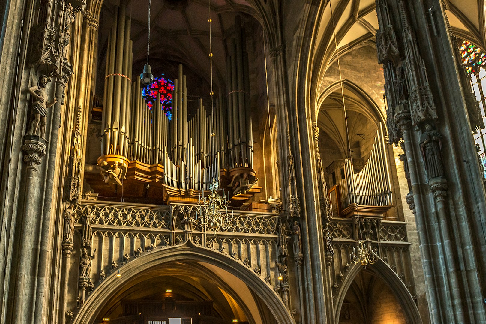 St. Stephen's Cathedral organ pipes and stained glass window in Vienna.