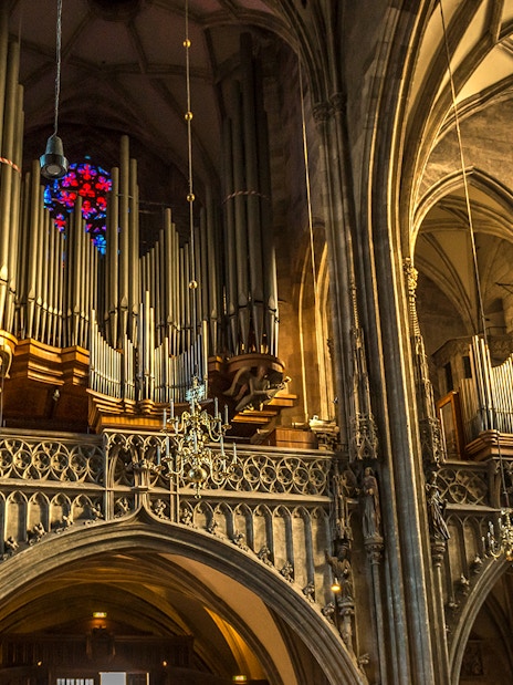 St. Stephen's Cathedral organ pipes and stained glass window in Vienna.