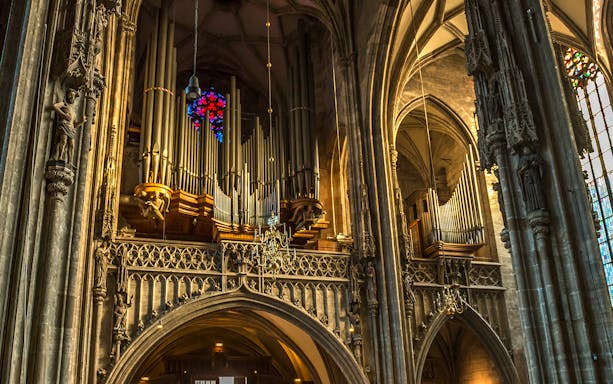 St. Stephen's Cathedral organ pipes and stained glass window in Vienna.