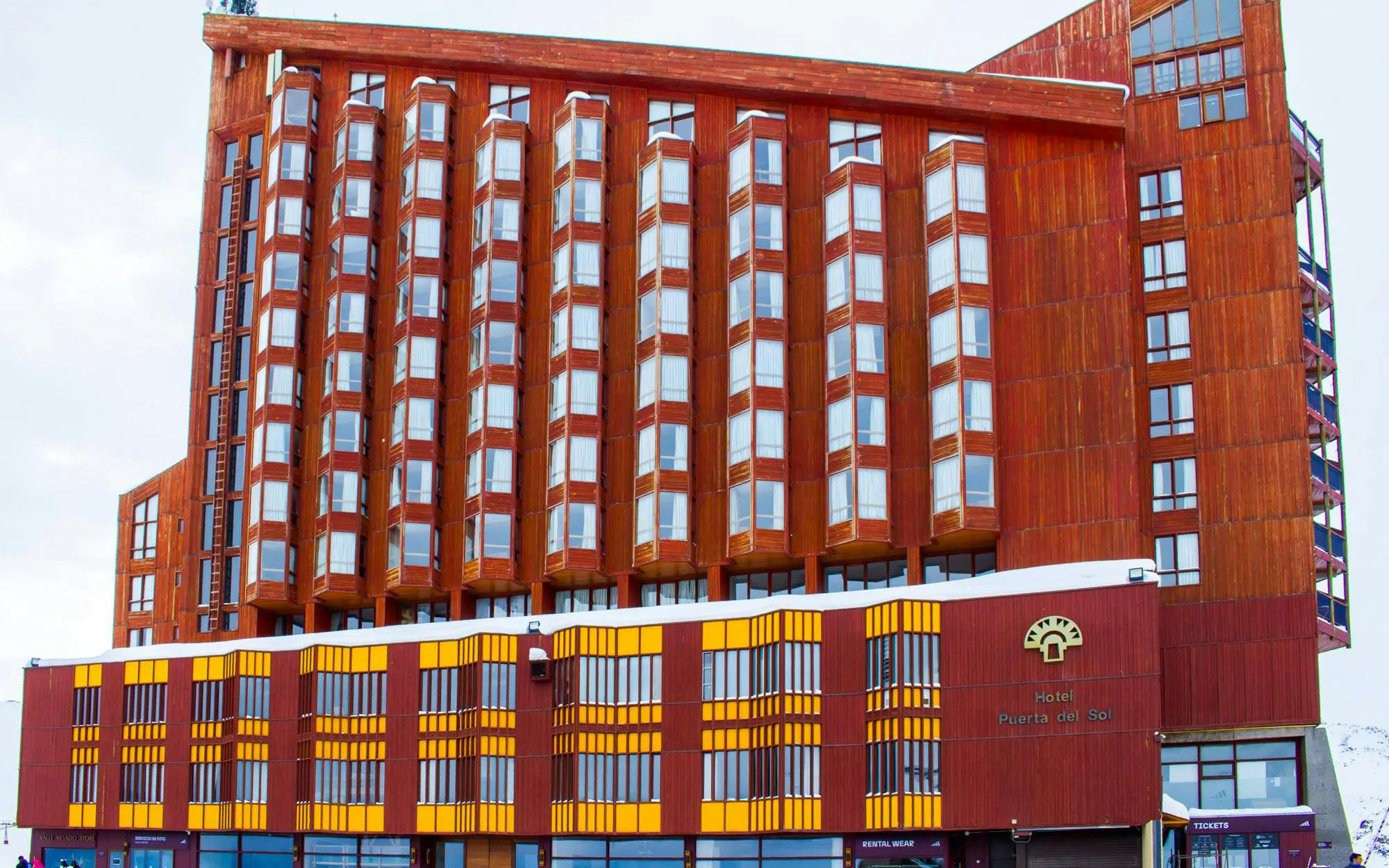 Hotel Puerta del Sol's wooden facade in Chile with large windows.