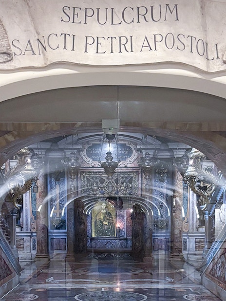 Tomb of St. Peter in St. Peter's Basilica, Vatican City, with ornate decorations and Latin inscription.