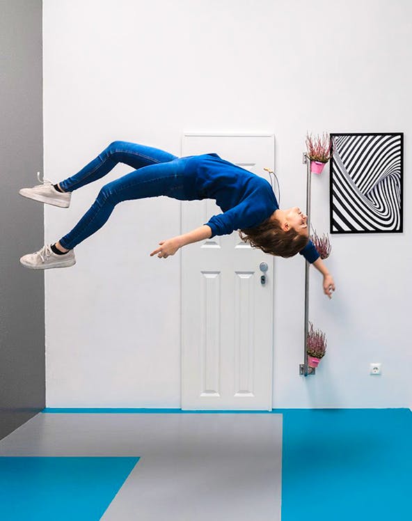 Person appearing to float sideways in a room at the Museum of Illusions.