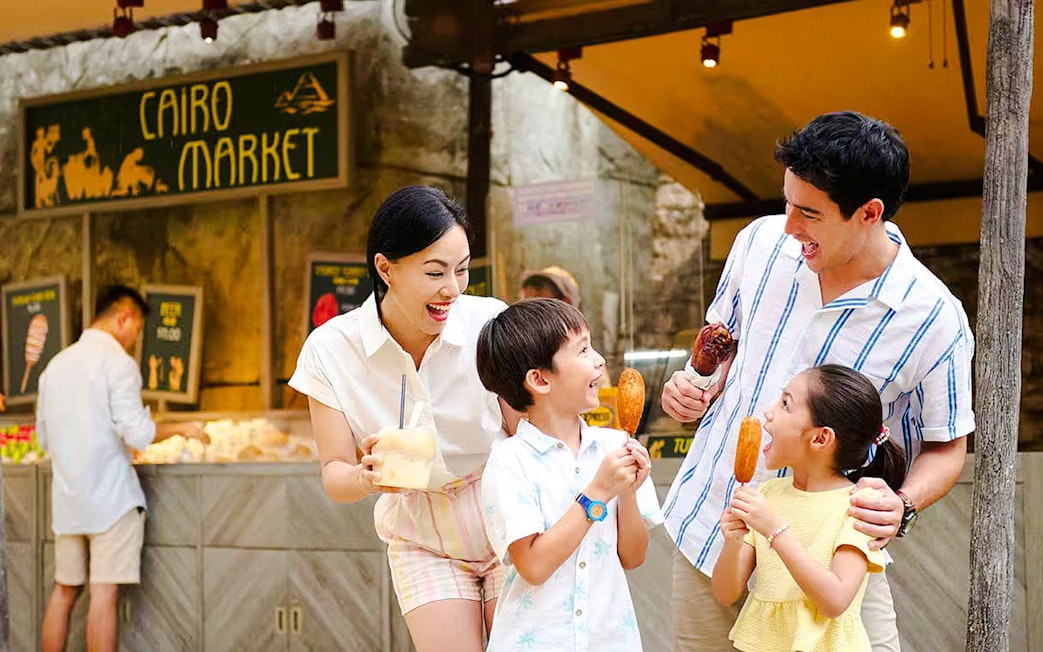 Family enjoying snacks at Cairo Market, Universal Studios Singapore.