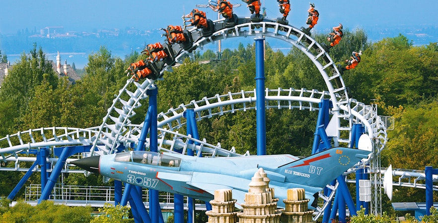 Roller coaster loop on Blue Tornado Ride at Gardaland Park, Italy, with jet-themed design.