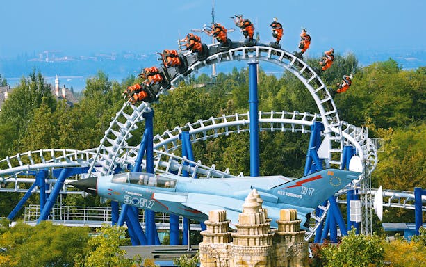 Roller coaster loop on Blue Tornado Ride at Gardaland Park, Italy, with jet-themed design.