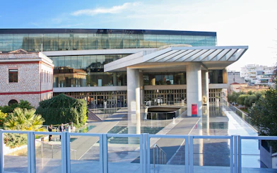 Acropolis Museum entrance in Athens, Greece with modern architecture and glass facade.