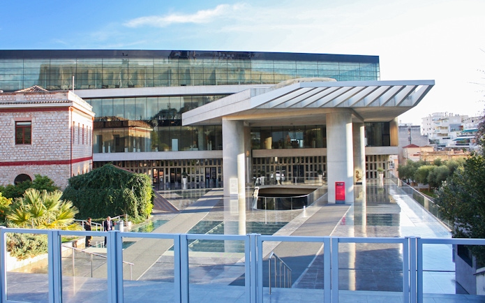 Acropolis Museum entrance in Athens, Greece with modern architecture and glass facade.