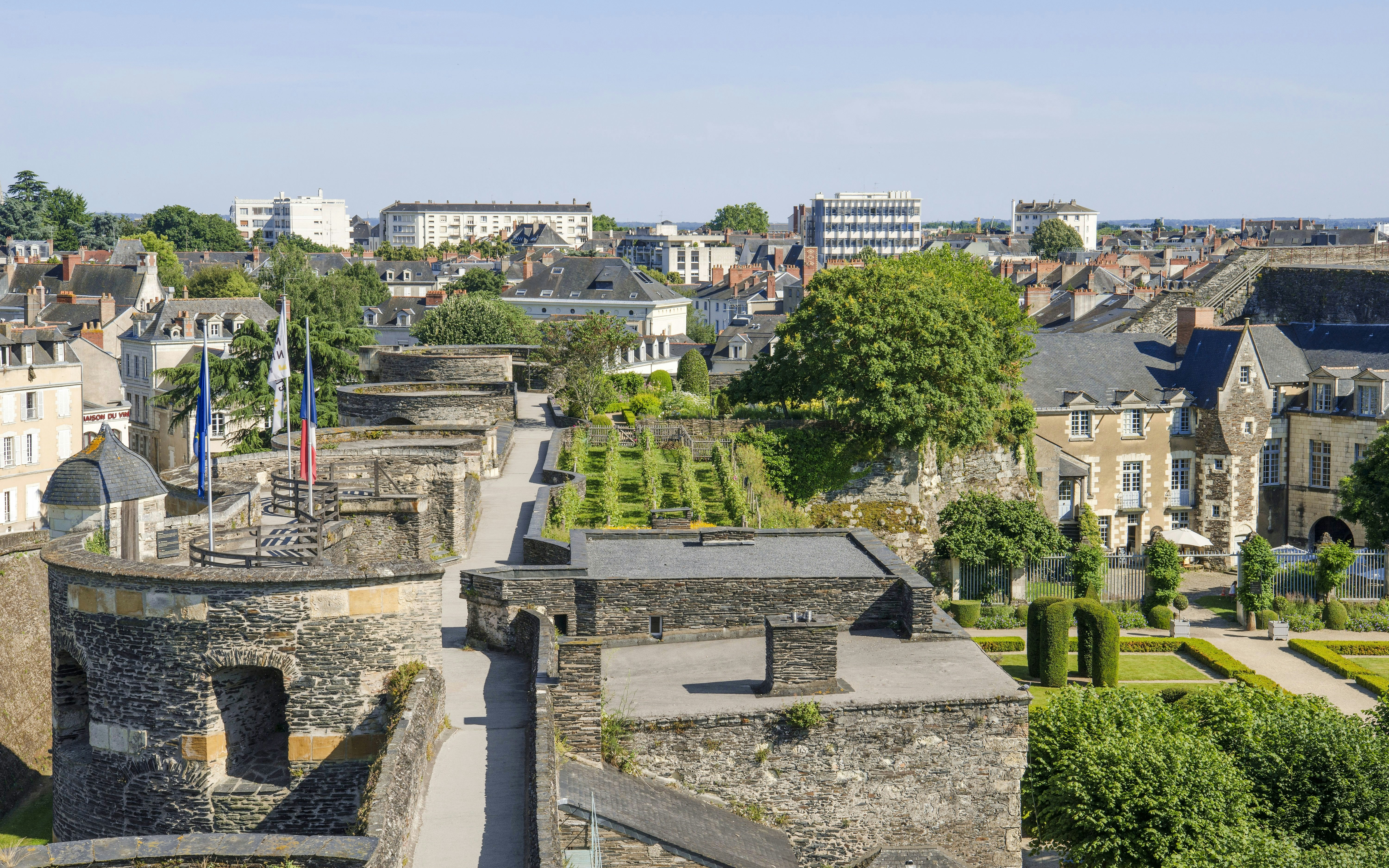 Tour du Moulin Château d’Angers with stone walls and gardens in Angers, France.