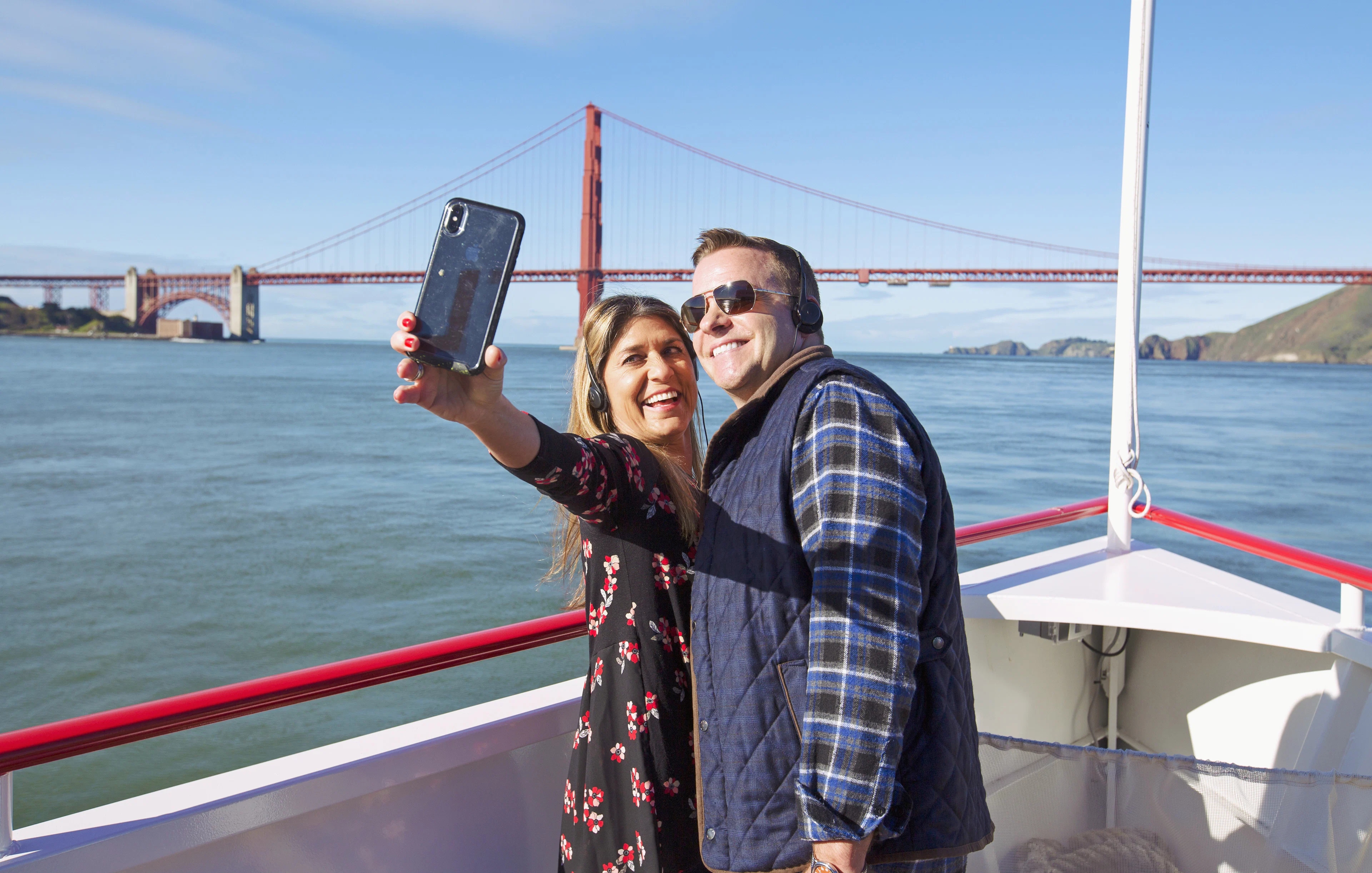 Couple taking a selfie on a Golden Gate Bridge cruise in San Francisco.