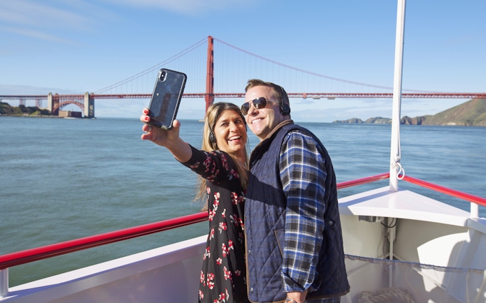Couple taking a selfie on a Golden Gate Bridge cruise in San Francisco.