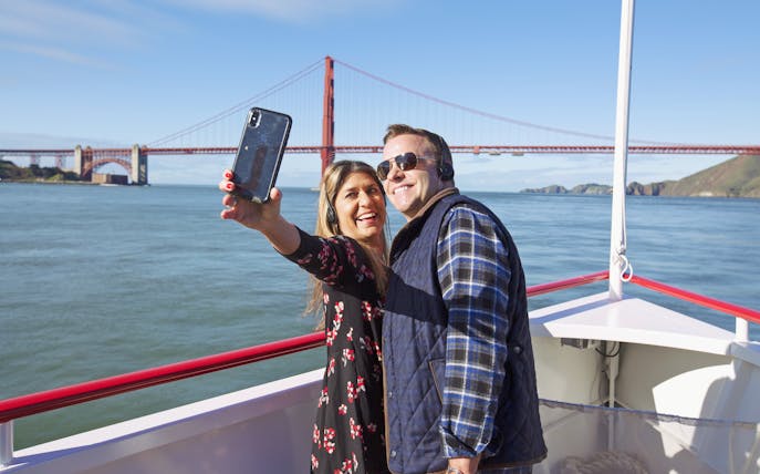 Couple taking a selfie on a Golden Gate Bridge cruise in San Francisco.