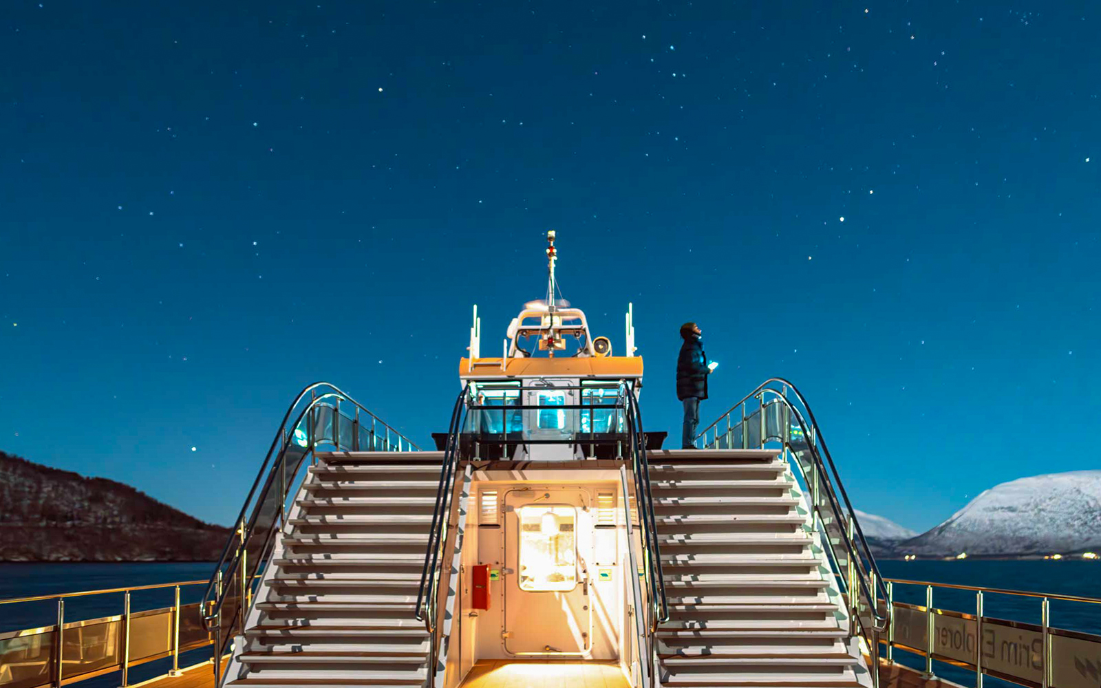 Cruise ship deck under starry sky during Aurora Boreal dinner cruise.