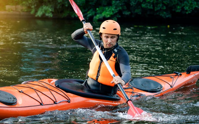 Kayaker paddling in Blue Eye, Albania.