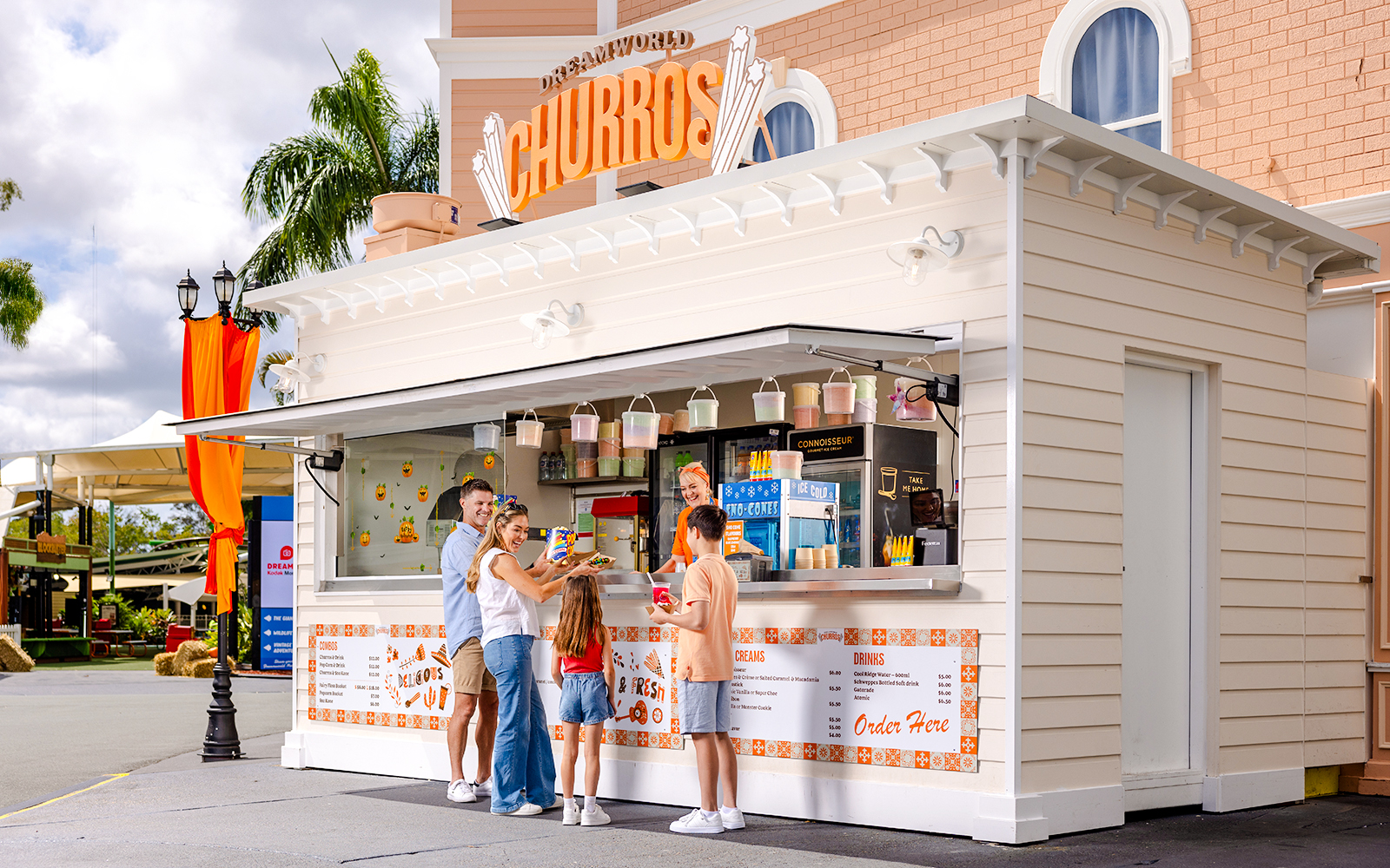 Churro stand at Dreamworld, Gold Coast, with visitors enjoying dining experience.