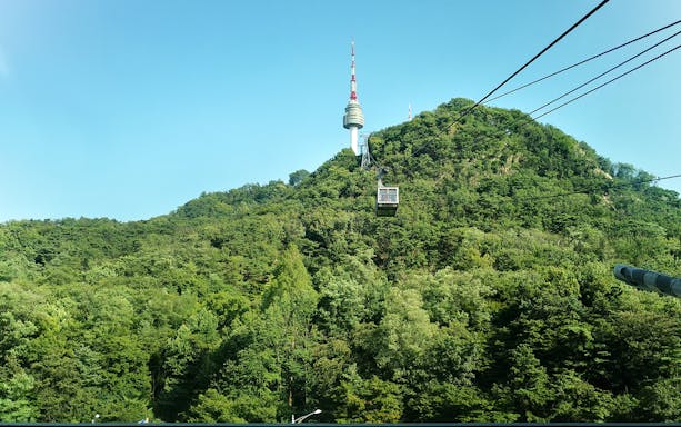 Cable car ascending with Namsan Tower in the background, Seoul, South Korea.