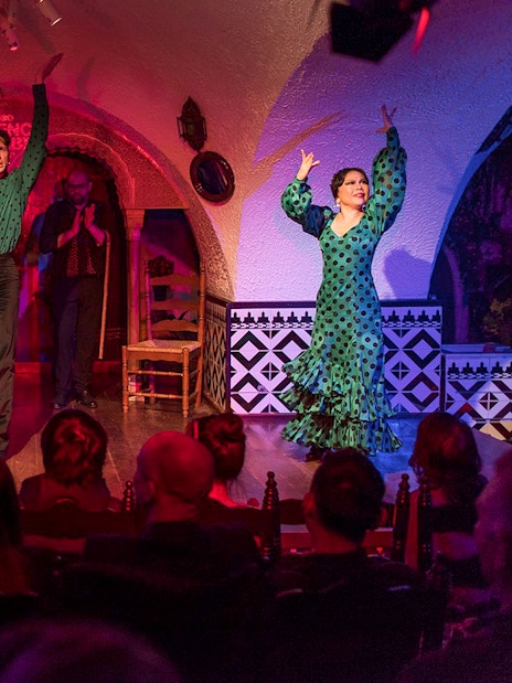 Tablao Cordobes Flamenco dancers performing on stage in a vibrant setting.