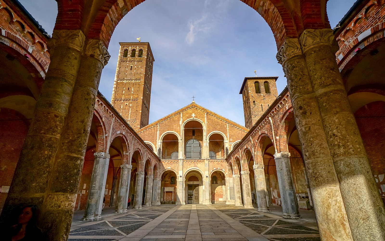 Basilica di Sant'Ambrogio exterior with Romanesque architecture in Milan, Italy.