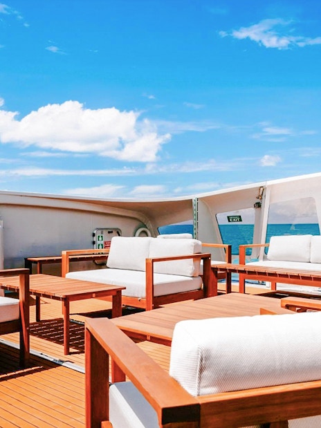 Outdoor seating area on a boat deck during ZigZag Whitsundays Day Tour.