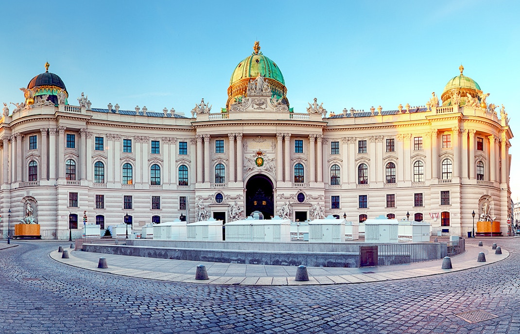 Hofburg Imperial Palace in Vienna with tourists exploring the historic architecture.