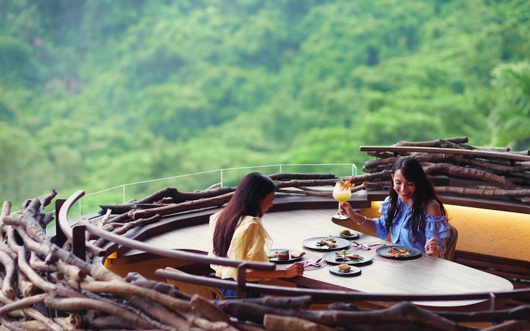 Dining with a view at JUNGLIA OKINAWA Park, surrounded by lush greenery.