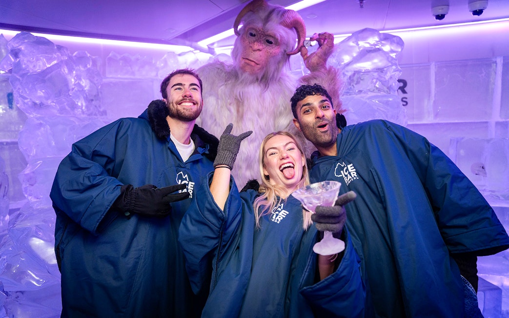 Group enjoying IceBar Surfers Paradise with ice sculptures and a yeti figure.