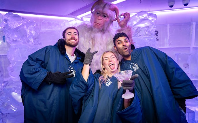 Group enjoying IceBar Surfers Paradise with ice sculptures and a yeti figure.