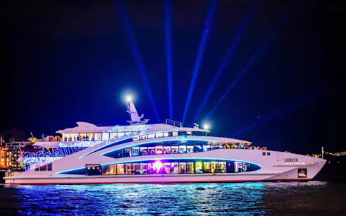 Luxury cruise ship The Jackson illuminated at night during Vivid Sydney festival.